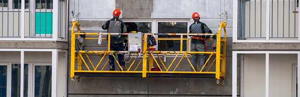 Men  with harnesses on manlift platform