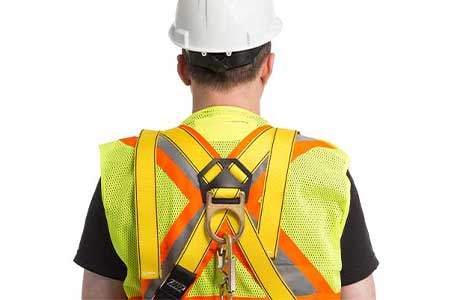 Fall arrest training harness on worker